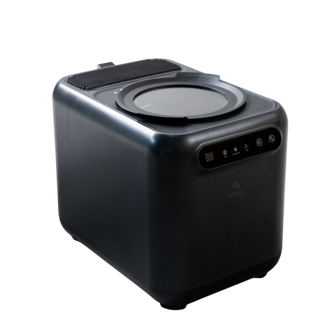 A sleek, black cube-shaped countertop electric composter with a circular top opening, a control panel with illuminated buttons, and a small logo on the front, shown on a plain white background.