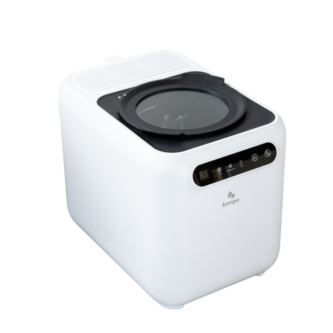 A compact white countertop appliance, to reduce food waste, shown on a plain white background. The brand name 'kompo' is visible on the front.